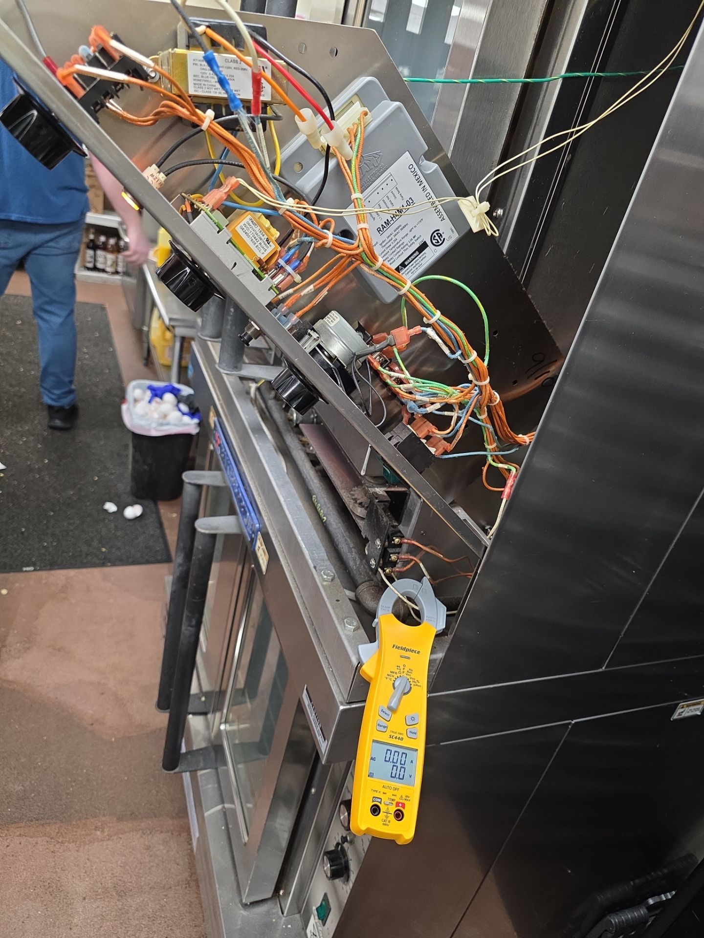AMB Works technician diagnosing Baker's Pride convection oven with Fieldpiece clamp meter