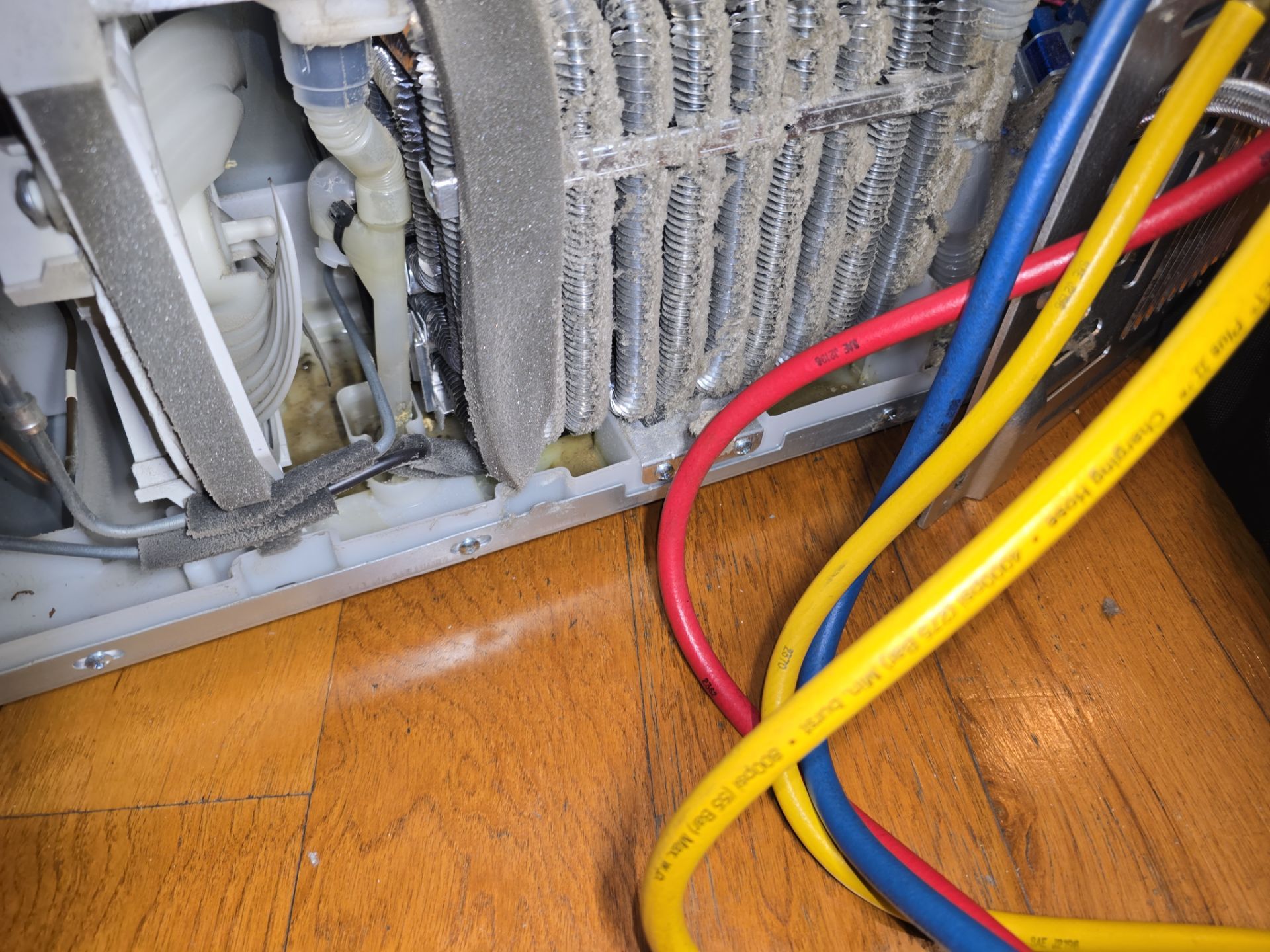 Close-up of failed LG compressor assembly removed during repair