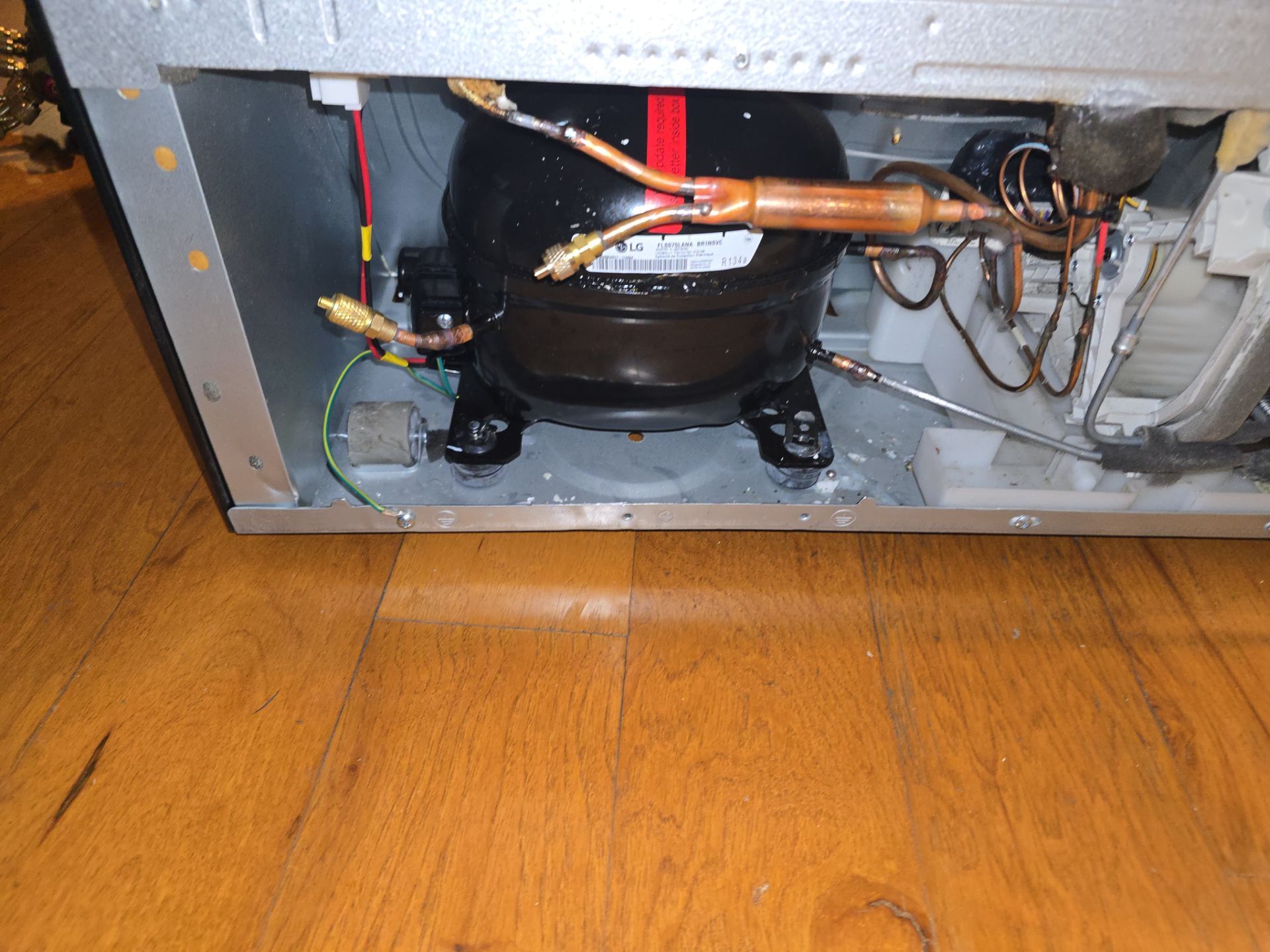 Refrigerant line showing oil staining from LG compressor leak