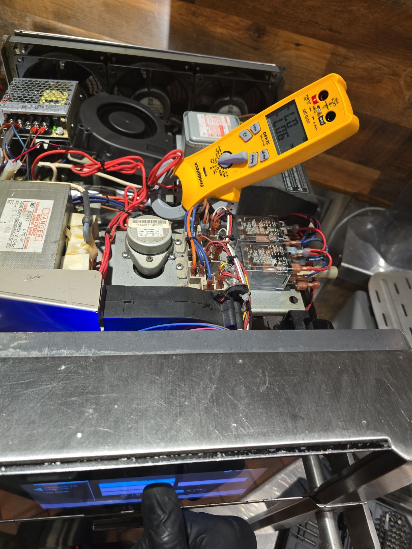 AMB Works technician using Fieldpiece SC440 clamp meter to diagnose TurboChef magnetron issues