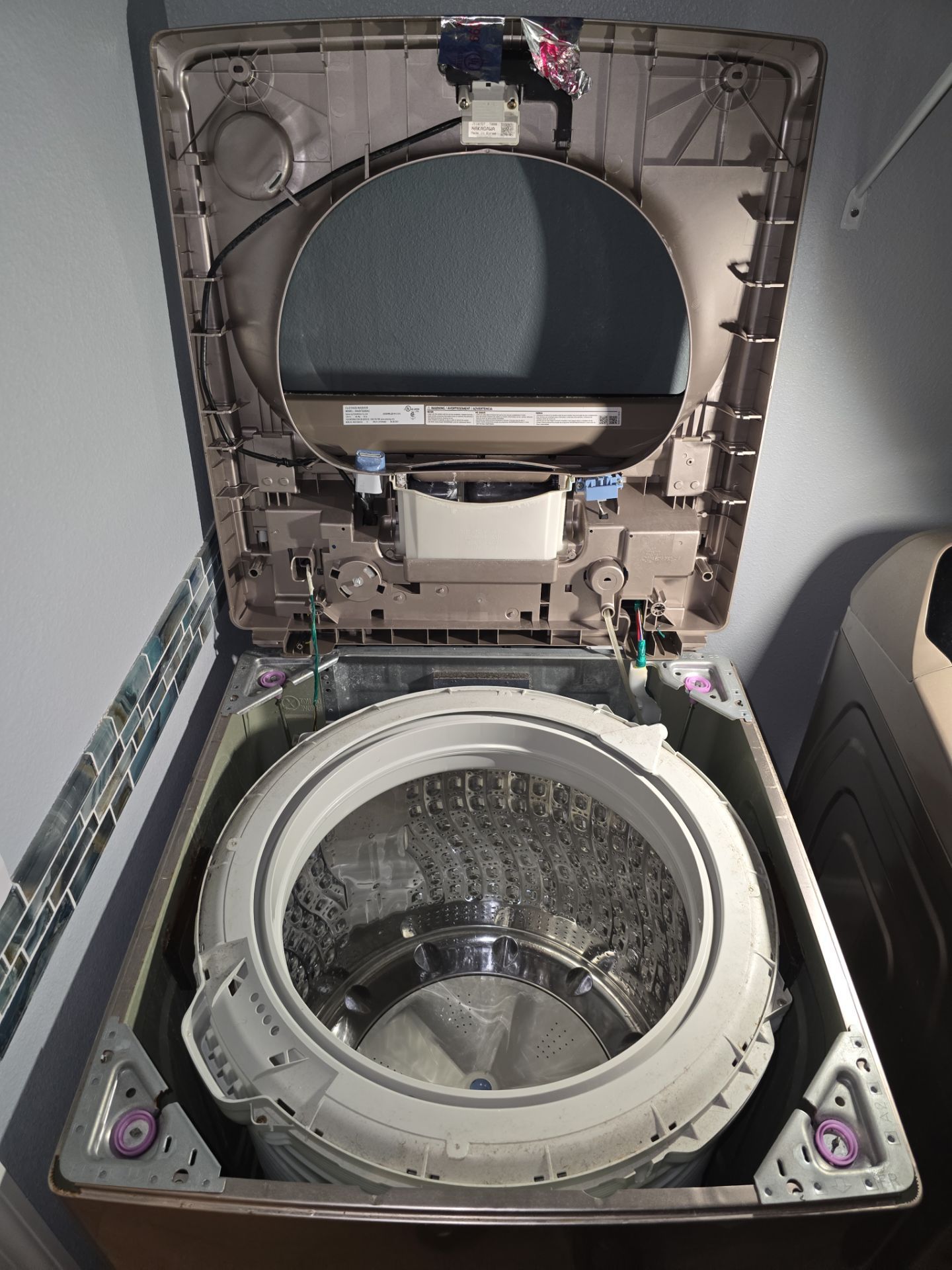 Samsung washer opened showing internal components and suspension rods - AMB Works technician diagnosis